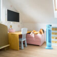 Modrá čistička vzduchu Ionic-CARE v detskej izbe, ružová škatuľa s plyšovými hračkami v pozadí